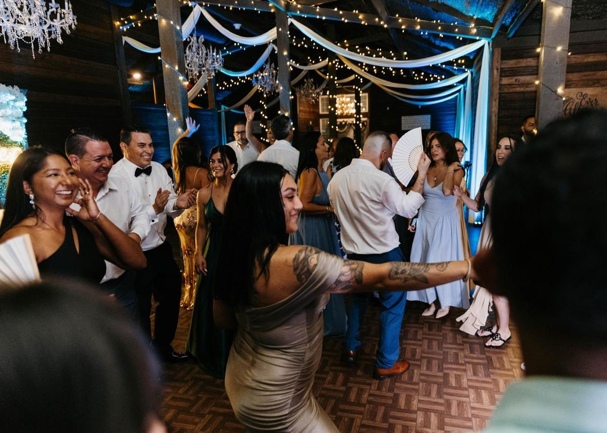 Party guests dancing in front of the DJ Calmet booth