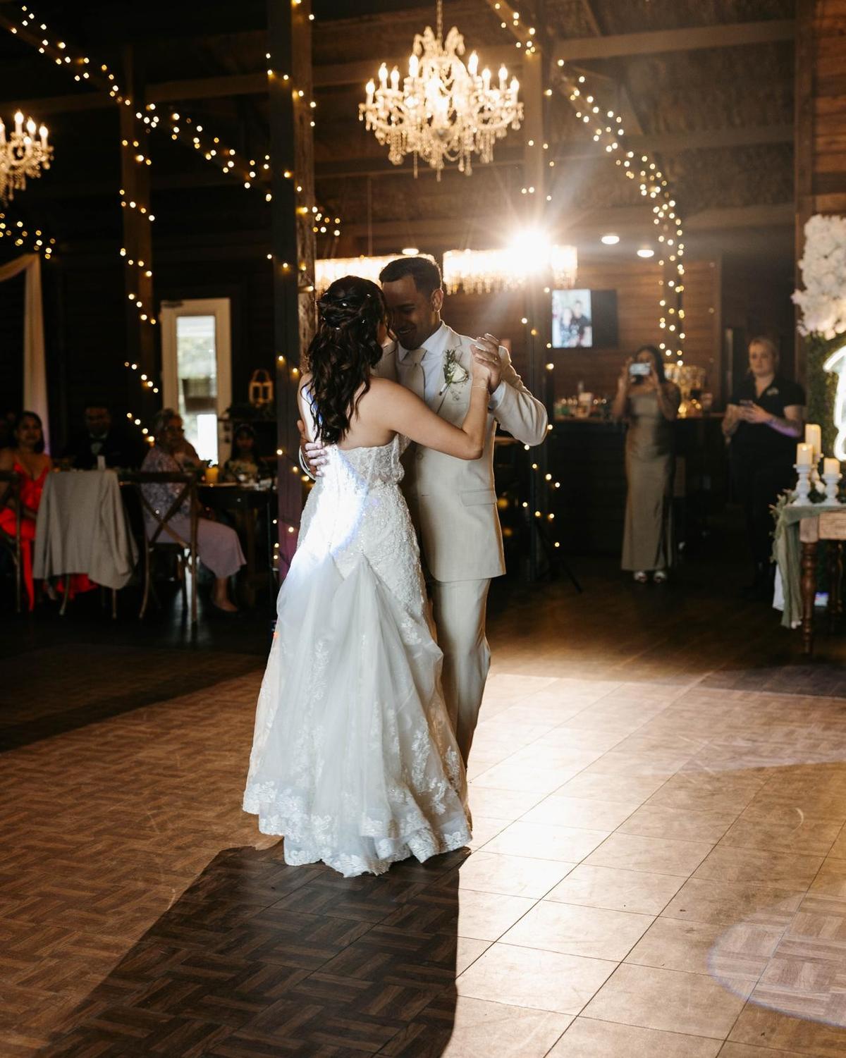 Bride and groom sharing their first dance under the lights, DJ Calmet